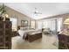 Bright bedroom featuring a ceiling fan, wood floors, neutral walls, and a sitting area with a large window at 1449 W Sherri Dr, Gilbert, AZ 85233