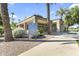 Community center features a covered entrance and seating area, with lush landscaping at 1449 W Sherri Dr, Gilbert, AZ 85233