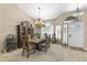 Elegant dining room with a large table set for a meal and a decorative chandelier at 1449 W Sherri Dr, Gilbert, AZ 85233