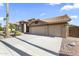 Wide driveway leads to a tan stucco home featuring a tile roof and a three-car garage at 1449 W Sherri Dr, Gilbert, AZ 85233