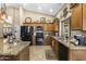 Kitchen featuring granite countertops, wood cabinets, and modern appliances at 1449 W Sherri Dr, Gilbert, AZ 85233