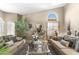 Cozy living room featuring plush sofas, stylish decor, and a bright arched window at 1449 W Sherri Dr, Gilbert, AZ 85233