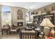 Elegant living room with a cozy fireplace, arched windows, and traditional furnishings at 1449 W Sherri Dr, Gilbert, AZ 85233