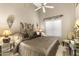 Serene bedroom with a neutral color palette, plush bedding, and a tray ceiling with fan at 1449 W Sherri Dr, Gilbert, AZ 85233