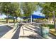 Shaded playground with modern equipment, surrounded by trees and lush greenery at 1449 W Sherri Dr, Gilbert, AZ 85233