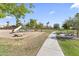 Enjoy the community playground with slide, grassy areas, benches, and a walking path at 1449 W Sherri Dr, Gilbert, AZ 85233