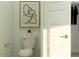 Elegant half bath features a modern toilet, white door, and neutral paint color at 15883 W Winslow Ave, Goodyear, AZ 85338