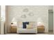 Cozy bedroom featuring a crib, soft lighting, and cloud decor at 15883 W Winslow Ave, Goodyear, AZ 85338