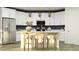 Modern kitchen featuring white cabinetry, a stainless steel refrigerator, and a center island with bar seating at 15883 W Winslow Ave, Goodyear, AZ 85338