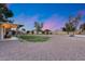Expansive backyard with large gravel area, basketball court, covered patio and potential for customization at 16437 N 61St Ave, Glendale, AZ 85306