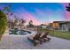 Inviting backyard featuring pool, lounge chairs, and home with a covered patio for relaxation and entertainment at 16437 N 61St Ave, Glendale, AZ 85306