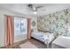 Bright bedroom with floral wallpaper, plush carpet and natural light at 16437 N 61St Ave, Glendale, AZ 85306