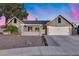 Charming single-story home with a two-car garage, complemented by professional landscaping and a brick entryway at 16437 N 61St Ave, Glendale, AZ 85306