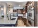 Spacious kitchen features stainless appliances, white countertops and beautiful dark wood cabinetry at 16437 N 61St Ave, Glendale, AZ 85306
