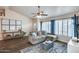 Inviting living room with wood floors, comfortable sofa, and large windows with plantation shutters at 16437 N 61St Ave, Glendale, AZ 85306