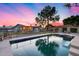 Sparkling pool nestled in a spacious yard, complimented with covered patio and manicured lawn at 16437 N 61St Ave, Glendale, AZ 85306