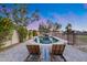 Relaxing pool area with elegant stone pavers, two lounge chairs, lush foliage, and a calming waterfall feature at 16437 N 61St Ave, Glendale, AZ 85306
