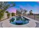 Inviting pool with a lovely waterfall feature, blue mosaic base, and a spacious patio area, creating a serene backyard oasis at 16437 N 61St Ave, Glendale, AZ 85306
