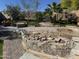 Picture of a backyard under construction with palm trees, a grill, and a pool surrounded by bricks at 16696 W Culver St, Goodyear, AZ 85338