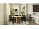 Bright dining area with a round table, dark chairs, and modern decor at 17363 W Fallen Leaf Ln, Surprise, AZ 85387