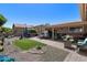 Spacious backyard featuring a covered patio, dining area, and manicured landscaping at 1753 Leisure World --, Mesa, AZ 85206