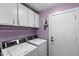 Functional laundry area with washer, dryer, and overhead storage cabinets at 1753 Leisure World --, Mesa, AZ 85206