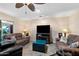Inviting living room with plush seating, ceiling fan, and a large television for entertainment at 1753 Leisure World --, Mesa, AZ 85206