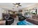 Cozy living room adjacent to kitchen, featuring tile floors and comfortable seating arrangement at 1753 Leisure World --, Mesa, AZ 85206