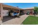 Outdoor patio with brick paving, dining set, and covered area for entertaining at 1753 Leisure World --, Mesa, AZ 85206