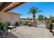 Open-air patio features a bistro set and a view of the desert landscaping and gated front yard at 1753 Leisure World --, Mesa, AZ 85206