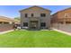 Spacious backyard with green artificial grass and a patio area, perfect for entertaining guests at 17560 W Young St, Surprise, AZ 85388