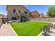 Spacious backyard featuring green artificial grass and a patio area, great for outdoor activities at 17560 W Young St, Surprise, AZ 85388