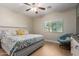 Relaxing bedroom features wood floors and a cozy chair by the bright window at 17560 W Young St, Surprise, AZ 85388