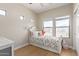 Charming bedroom with a decorative butterfly on the wall, a bed, and two bright windows at 17560 W Young St, Surprise, AZ 85388