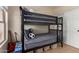 Stylish bedroom featuring a black bunk bed with wood floors and natural light from the window at 17560 W Young St, Surprise, AZ 85388