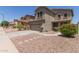 View of a two-story home with desert landscaping, and a two-car garage at 17560 W Young St, Surprise, AZ 85388