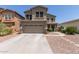 Charming two-story home featuring a two-car garage, desert landscaping, and a welcoming facade at 17560 W Young St, Surprise, AZ 85388