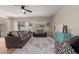 Bright living room featuring neutral walls, a ceiling fan, plush sofas, and an area rug at 17560 W Young St, Surprise, AZ 85388