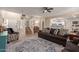 Open-concept living area with staircase and view into the kitchen, offering a cozy atmosphere at 17560 W Young St, Surprise, AZ 85388