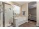Bright primary bathroom featuring a walk-in shower and soaking tub at 17560 W Young St, Surprise, AZ 85388