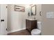 Stylish powder room featuring a wood vanity, framed mirror, and neutral walls at 17560 W Young St, Surprise, AZ 85388