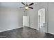 Spacious bedroom features wood floors, a ceiling fan, and an open doorway to the bathroom at 1821 S Navajo Way, Chandler, AZ 85286