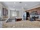 Stylish kitchen with granite countertops, an island, stainless steel appliances, and dark wood cabinetry at 1821 S Navajo Way, Chandler, AZ 85286