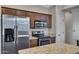 Kitchen with stainless steel appliances, granite counters, an island, and dark wood cabinetry at 1821 S Navajo Way, Chandler, AZ 85286