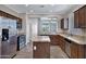 Gourmet kitchen featuring granite countertops, a center island, wood cabinets and stainless appliances at 1821 S Navajo Way, Chandler, AZ 85286