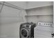 A bright laundry room featuring modern washer, dryer, and shelving at 1821 S Navajo Way, Chandler, AZ 85286