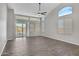 Bright living room featuring vaulted ceilings, tile flooring, with sliding glass doors and large windows at 1821 S Navajo Way, Chandler, AZ 85286