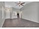 Open-concept living room featuring neutral paint, tile flooring, and an open view to the kitchen at 1821 S Navajo Way, Chandler, AZ 85286