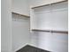 A spacious walk-in closet with wood shelves and a neutral color palette at 1821 S Navajo Way, Chandler, AZ 85286