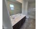 Bathroom featuring double sinks, dark wood cabinets, and a shower-tub combination at 18361 E Eloisa Dr, Gold Canyon, AZ 85118